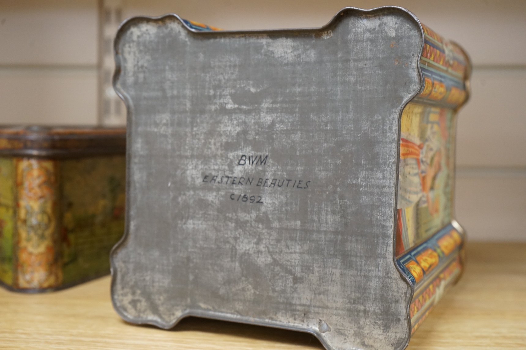 A Windmill biscuit tin by Huntley & Palmer: Reading & London, 'BIVM' Eastern Beauties tea tin and Huntley & Palmers triangular biscuit tin with 'Sports' motifs